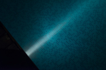 lighting from spotlights fittings underwater in the swimming pool at nighttime. Top view