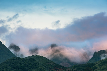 Fototapeta premium clouds twining round the green mountain
