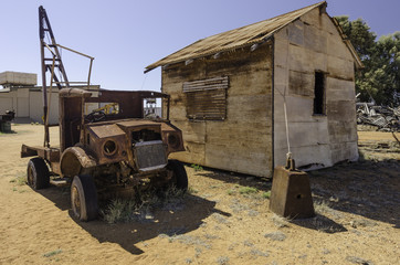 Fototapeta na wymiar Rusting, derelict tow truck and old hut at One Mile Jetty, Carnarvon, Western Australia, Australia.