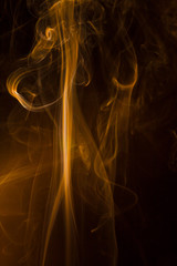 Gold smoke on black background.