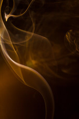 Gold smoke on black background.