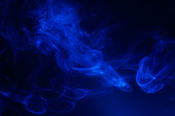 Blue smoke on black background.