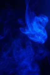 Blue smoke on black background.