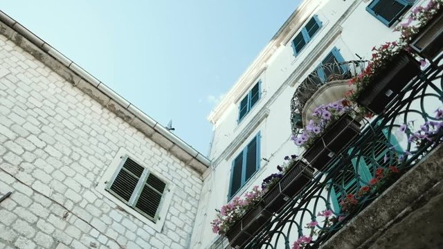 Part of the building with a balcony and flowers. Old Town in Kotor, Montenegro
