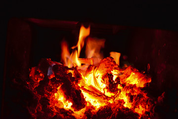 Firewood burning in the stove. Soft focus. Abstract background for design and project.