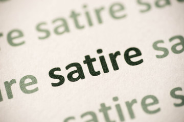 word satire   printed on paper macro