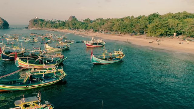 Indonesia traditional fishing boats docked in shores after fishing an aerial view, Papuma beach Jember