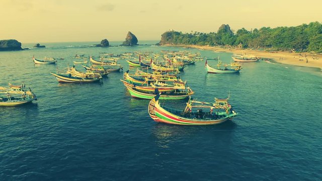 Indonesia traditional fishing boats docked in shores after fishing an aerial view, Papuma beach Jember