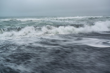 Black volcanic sand at Khalaktyrsky beach of the Pacific at Kamchatka peninsula, near Petropavlovsk-Kamchatsky, Russia