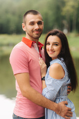 Fototapeta premium Beautiful couple walking in the park near the lake