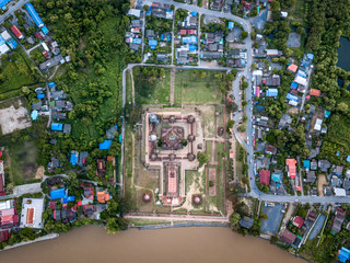 Aerial view of old temple is a buddhist temple in the city of Ayutthaya Province, Thailand, beside Chao Phraya river, aerial view from flying drone, view from green zone.  
