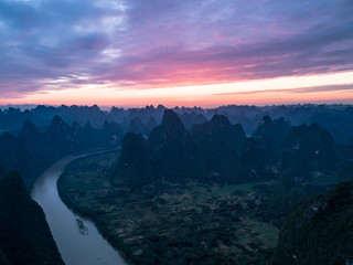 aerial view of farmland, river and mountain in the dawn