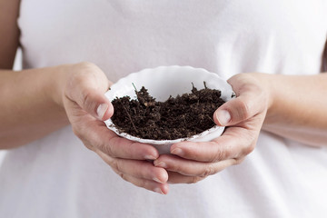 A woman holding soil