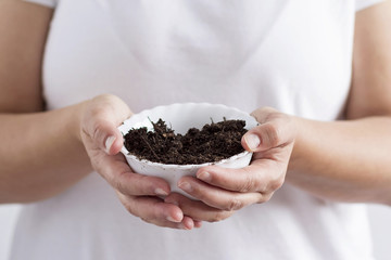 A woman holding soil