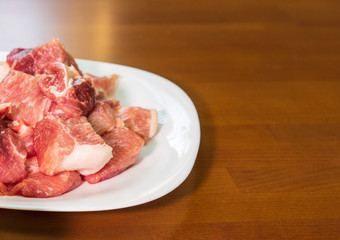 Raw piece of meat on plate.