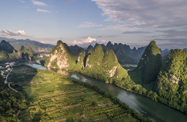 aerial view of farmland and mountain around the ancient town of Xingping, China