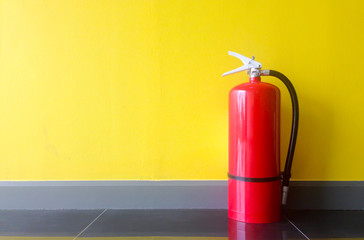 Fire extinguisher on yellow background.
