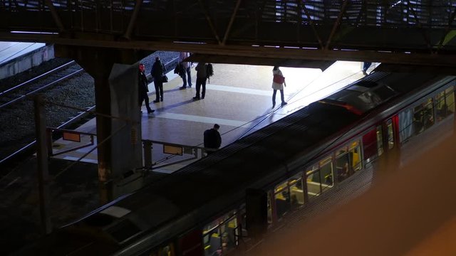 Obscured View of Train Leaving Central Station with Mysterious Man Waiting in Shadows