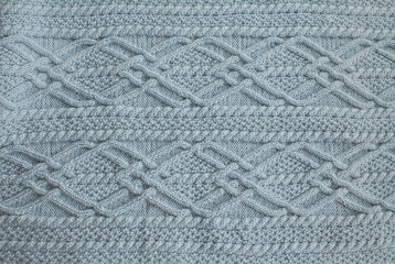 Seamless blue Knitwear Fabric Texture with Pigtails. Repeating Machine Knitting Texture of Sweater. Blue Knitted Background.