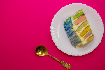 cake with a rainbow filling, on a crimson background