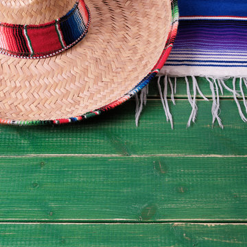 Mexico cinco de mayo fiesta carnival traditional green wood background border mexican sombrero serape rug or blanket photo square format