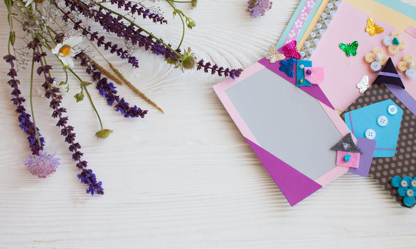 Postcard from paper flowers. Scrapbooking, creative mess. The view from the top.
