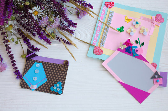 Postcard from paper flowers. Scrapbooking, creative mess. The view from the top.