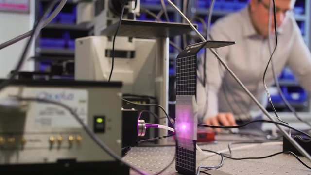 Testing a laser in a laboratory with microscopes.