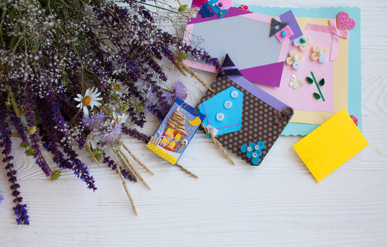 Postcard from paper flowers. Scrapbooking, creative mess. The view from the top.