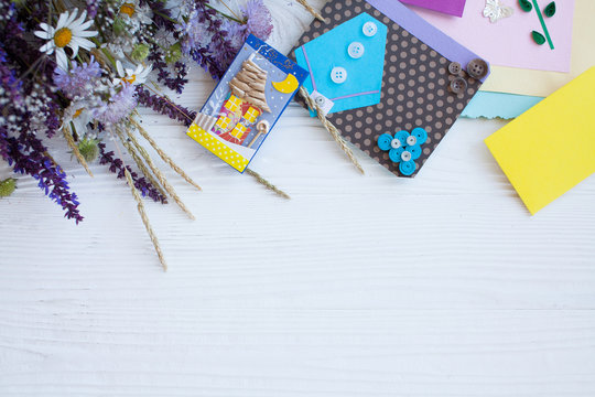 Postcard from paper flowers. Scrapbooking, creative mess. The view from the top.