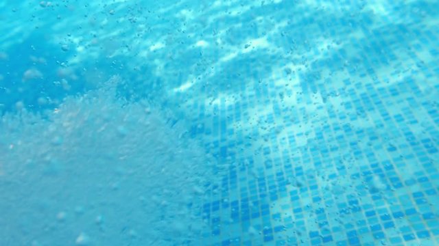Bubbles rising to the surface. Air bubbles in water in swimming pool (underwater shot), good for backgrounds. Slow motion.
