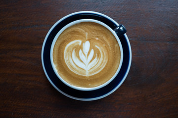 Latte art on the wood table background. (Black and white)