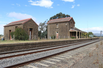 Fototapeta na wymiar CARLSRUHE, AUSTRALIA - February 25, 2018: The Carlsruhe railway station and lamp room (1862), built of local bluestone with a slate roof, is now a private residence