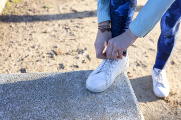 Woman tying the shoelaces on running track