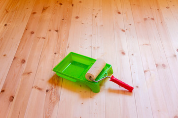 Paint roller brush on wood background