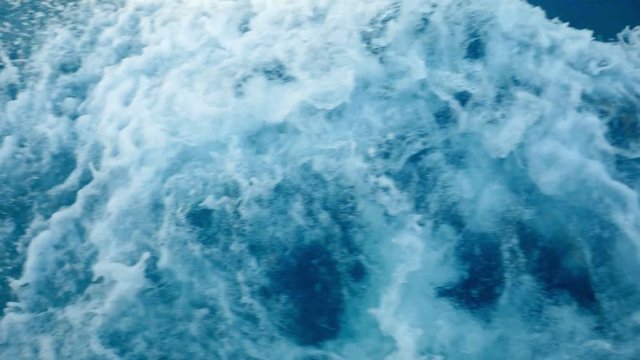 Blue sea water with boat trace. Slow motion.
