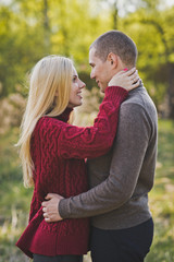 Fototapeta premium A young couple in love embracing against the background of reeds 1352.
