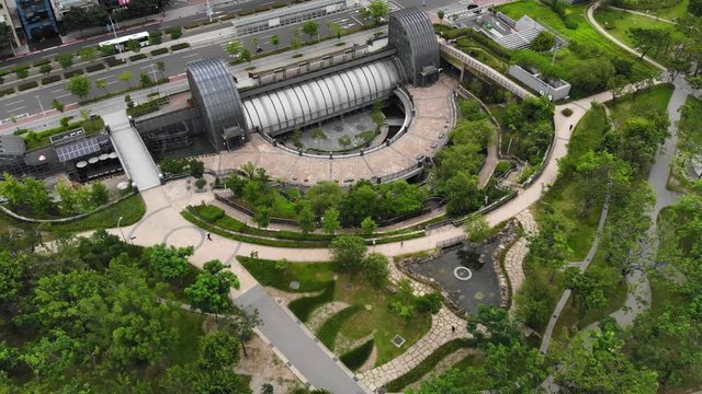 Wide aerial view of oval pavilion complex and circular gardens in Daan Park, Taipei, Taiwan