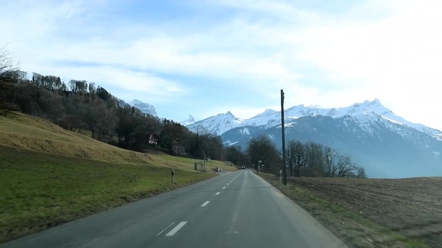 Mountain road POV, driving on road with bare treee and branches during winter season10