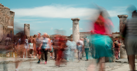 tourists slow motion in the ancient ruins of the forum at pompeii, that was buried by the eruption...