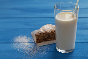 Glass of milk and piece of sugar cake