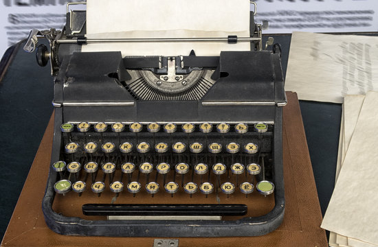 typewriter with Russian font with paper sheet.