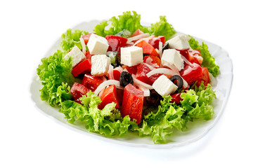 Fresh Greek salad in plate isolated on white background