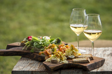 Italian appetizer with white wine on wood table