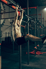 Fototapeta na wymiar Concept: power, strength, healthy lifestyle, sport. Powerful attractive muscular man at gym