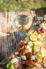 Italian appetizer with white wine on wood table