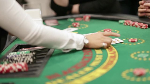 Blackjack dealer starging a new game by distributing cards