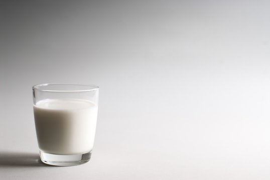 Glass of milk on a white background