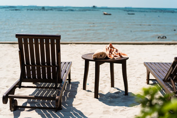 Wooden sunbed on the beach next to the sea