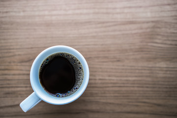 A cup of coffee on the wooden table